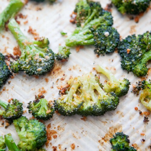 Upclose of parmesan smashed broccoli floret on sheet pan.