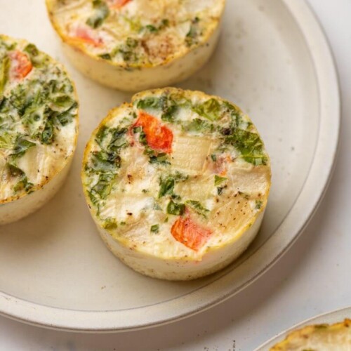 Three egg white cups on plate.