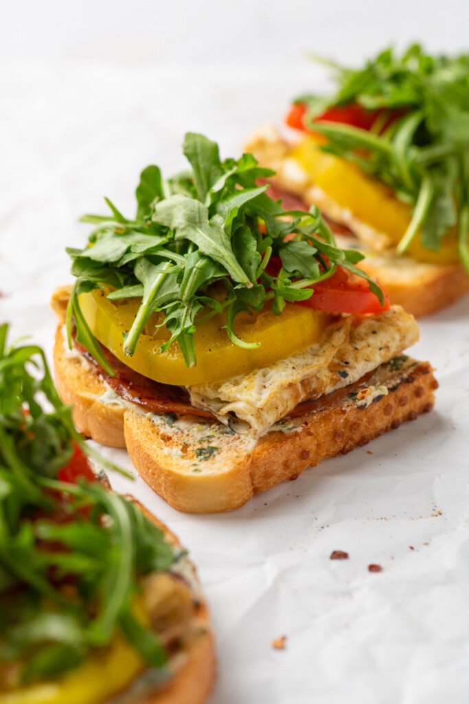 Tomato basil egg toasts with toppings.