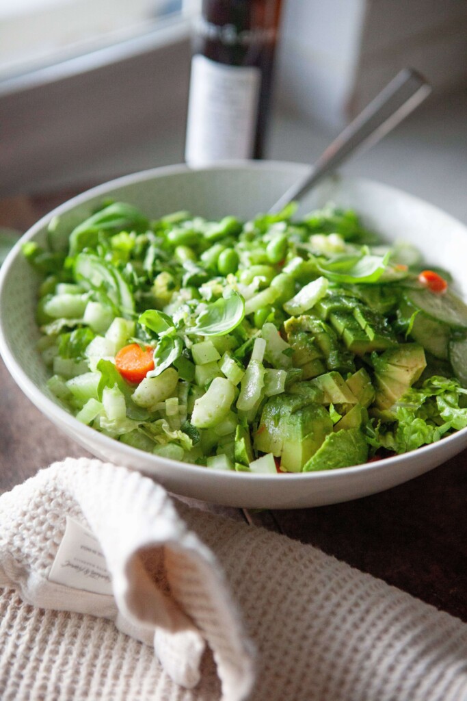 House salad served in bowl with fork on the side.