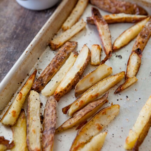 Thick cut oven roasted fries on baking sheet.
