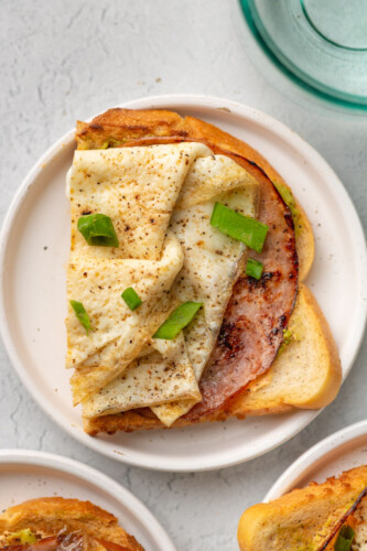 Chipotle egg white toasts on a small white plate.