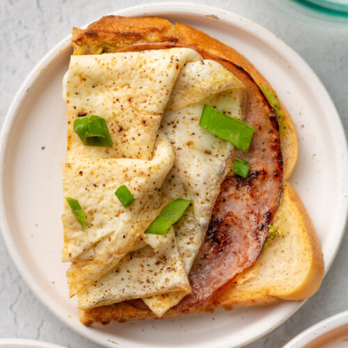 Chipotle egg white toasts on a small white plate.