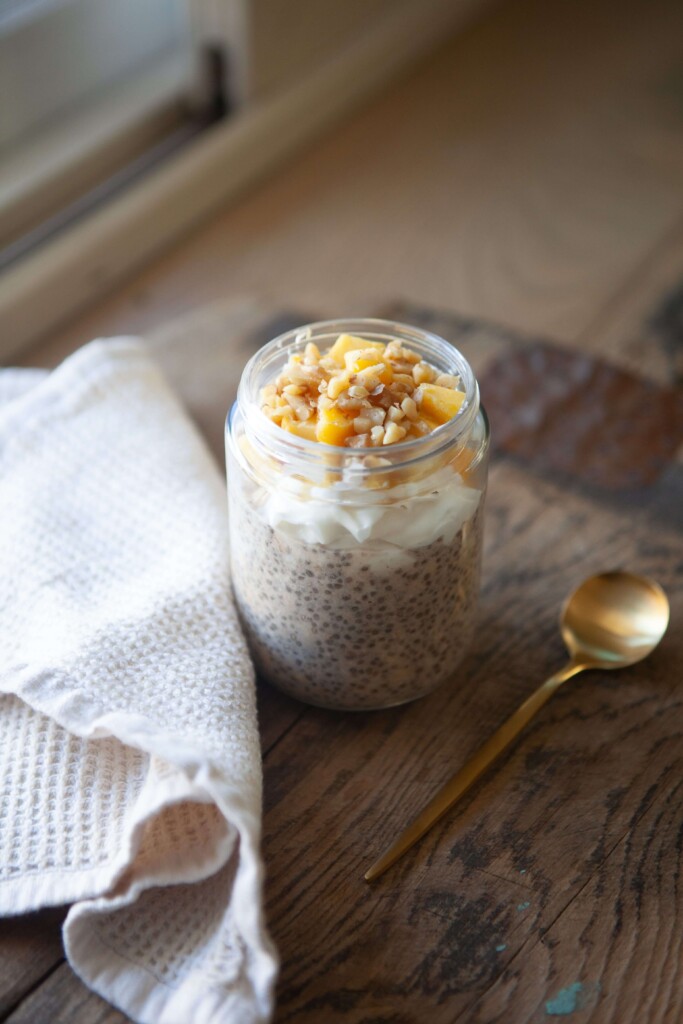 Mango and walnut overnight oats make in a jar and topping with toppings.