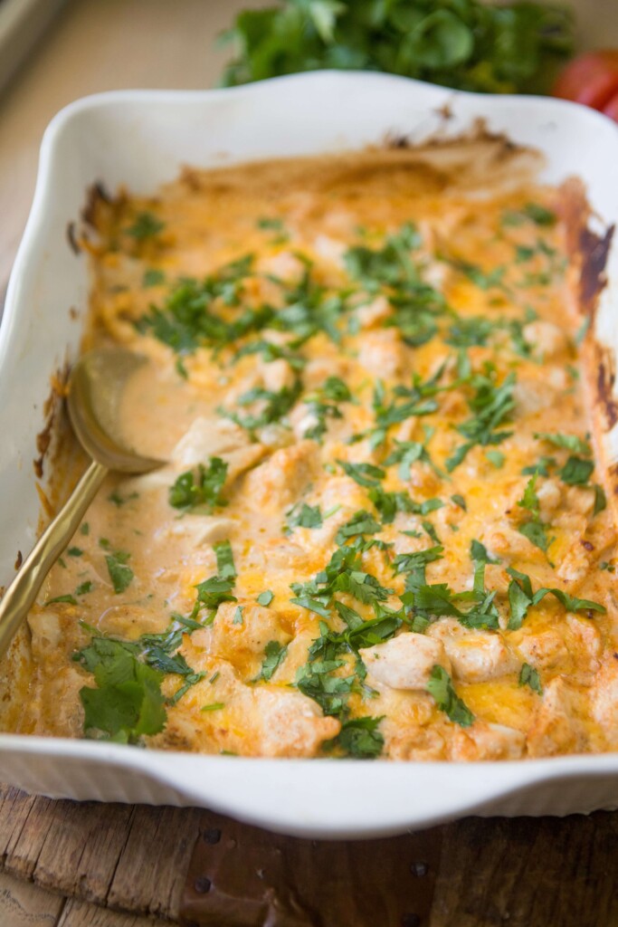 Spoon digging into creamy mexican chicken bake.
