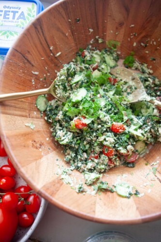 Greek kale and lentil salad tossed in wood salad bowl.