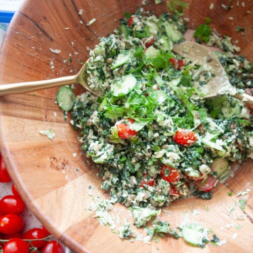 Greek kale and lentil salad tossed in wood salad bowl.