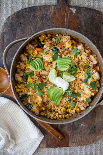 Zucchini, corn and chicken skillet topped with toppings in skillet.