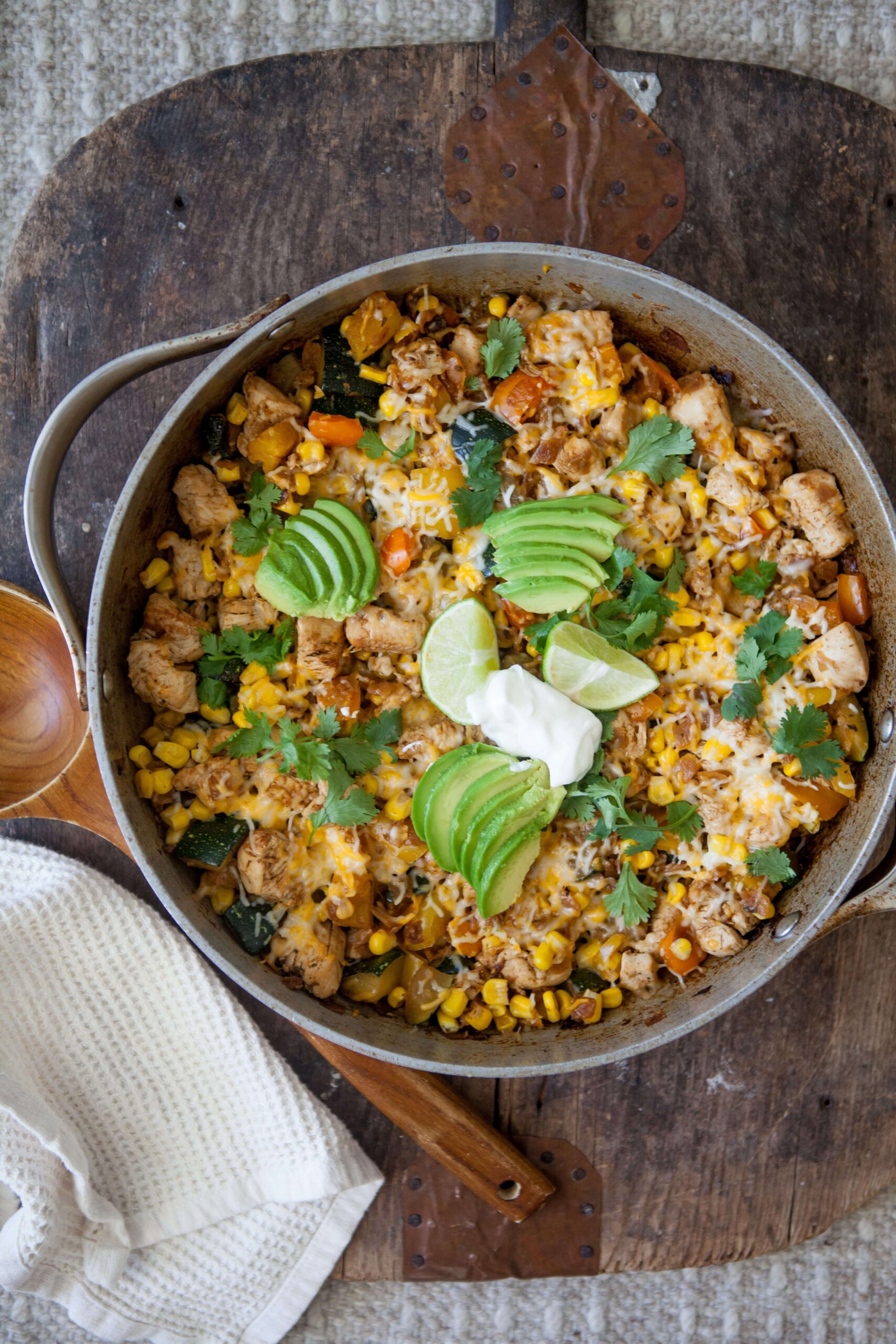 Zucchini, corn and chicken skillet topped with toppings in skillet.