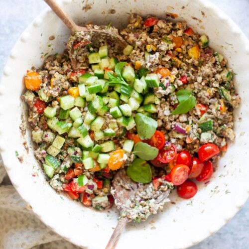 All the ingredients for lentil salmon salad in large white bowl.