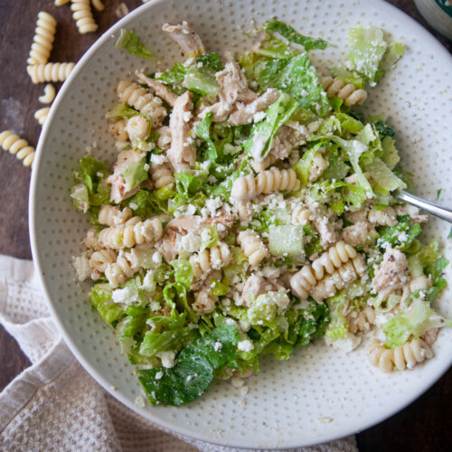 Caesar pasta salad in a white bowl.