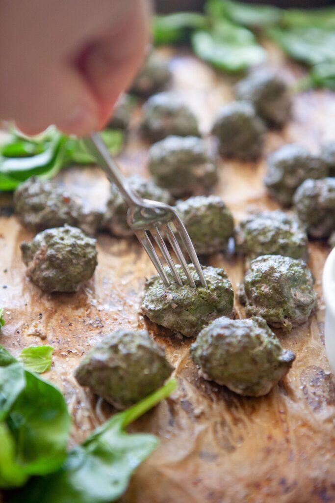 Close-up of baked spinach basil meatballs made with lean ground beef and cottage cheese